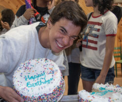 Teenager smiling with birthday cake