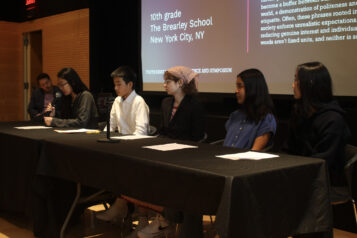 One panelist is talking into the microphone while the other Panelists are waiting