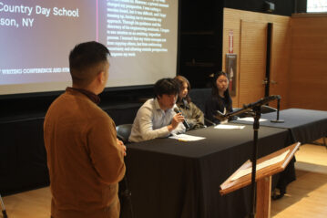 A moderator waiting for a panelist to finish his remarks
